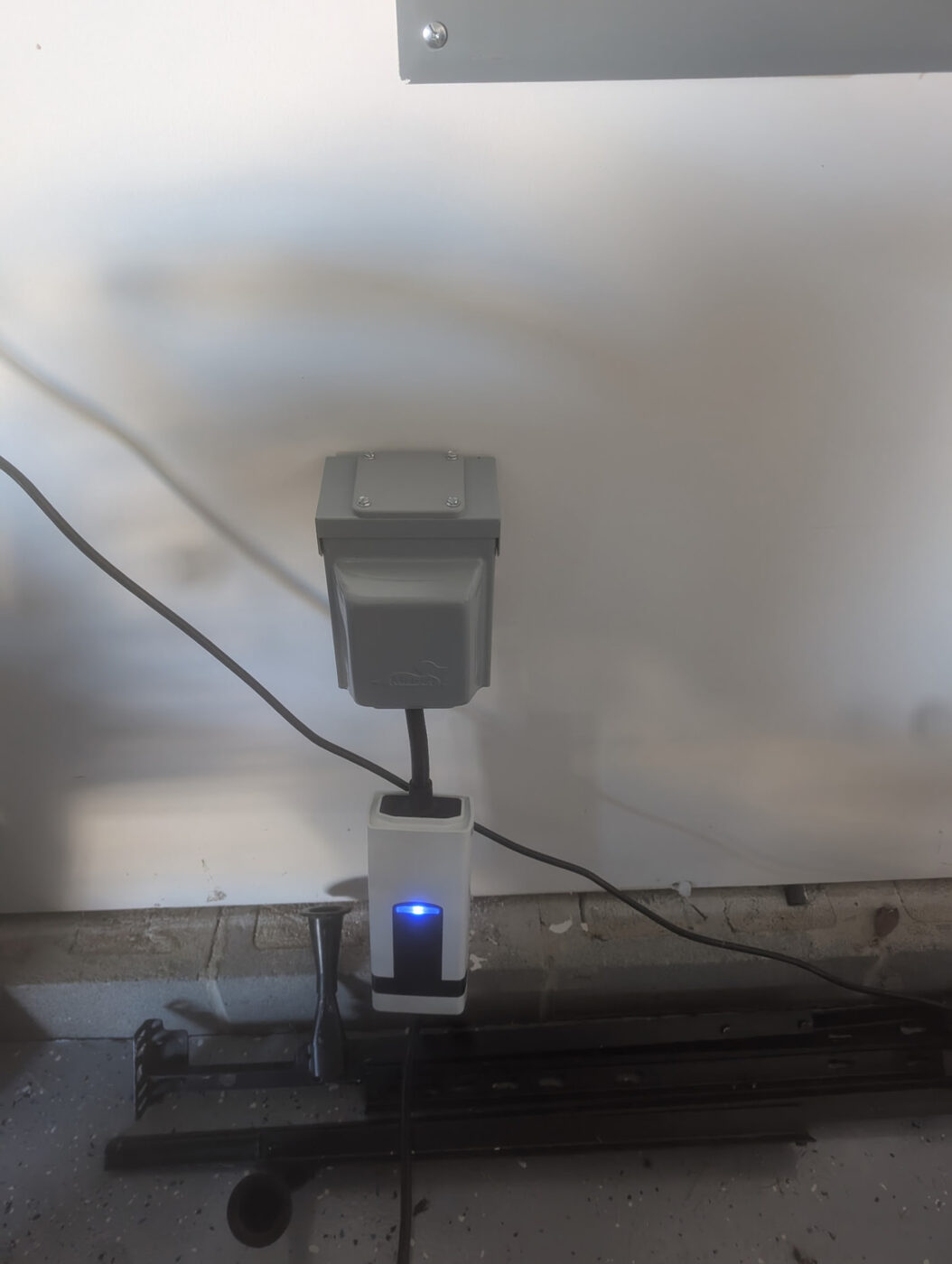 Garage NEMA 14-50 enclosure powering a Level 2 mobile connector