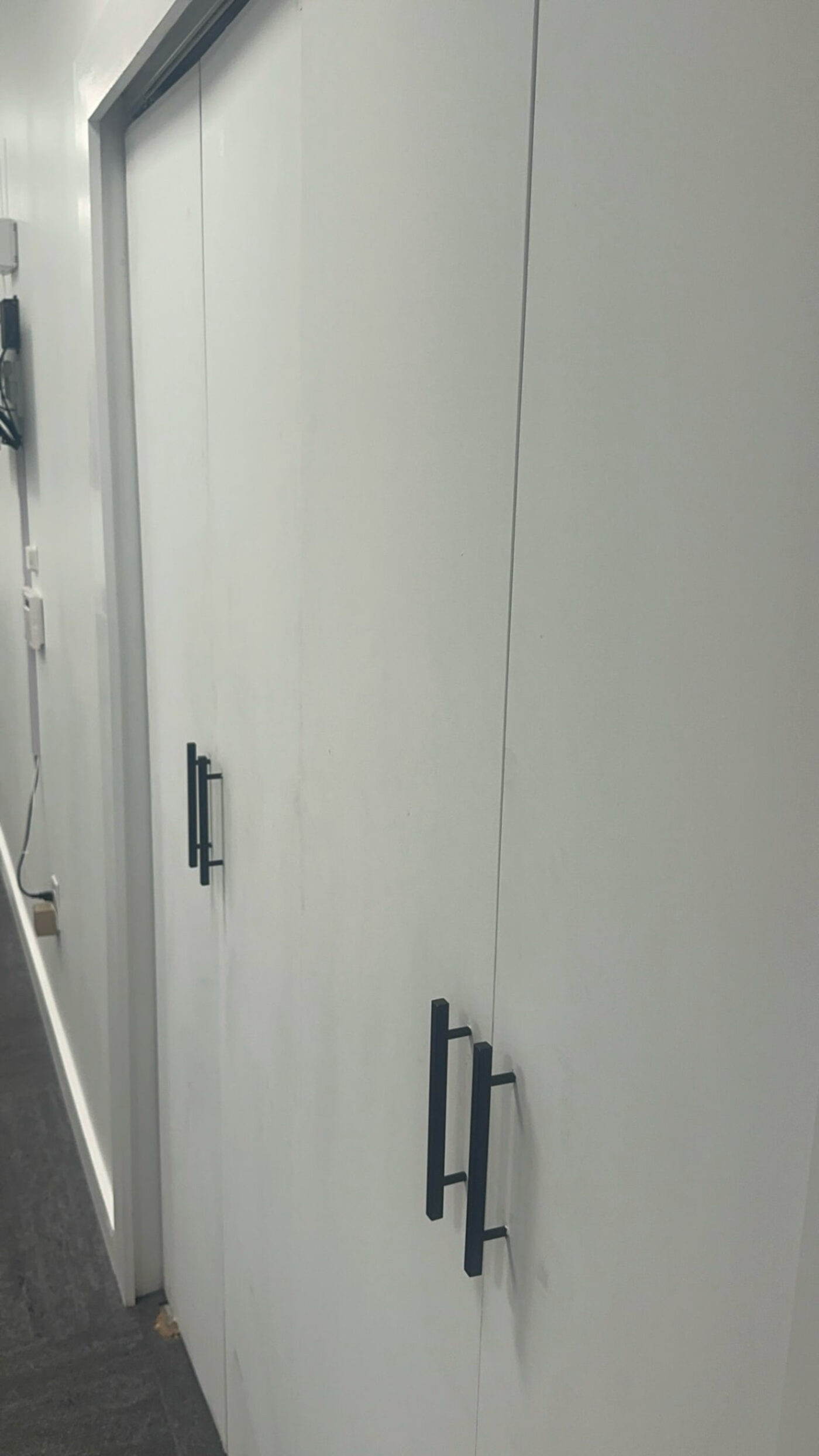 Matte black pull handles installed on storage doors