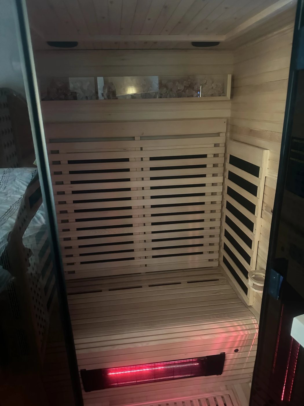 Sauna bench, heaters, and salt-stone shelf finished out