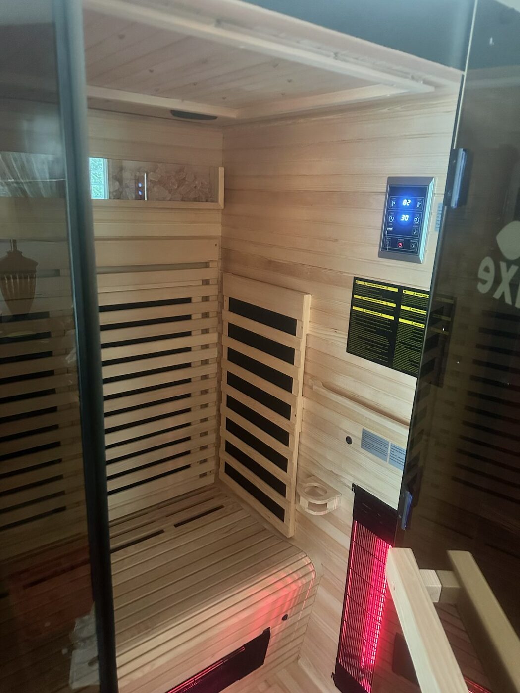 Sauna interior — panels, bench, and controls fitted